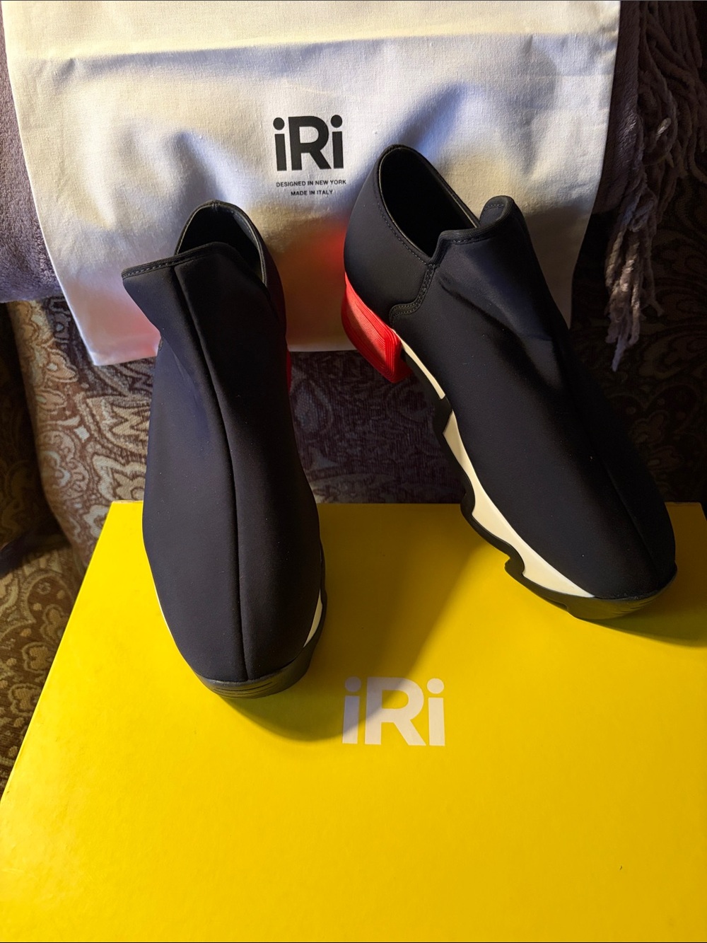 iRi Women’s Black Slip-On Sneakers with Red Heel Accent